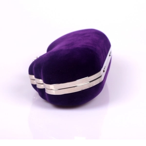 Detail view of purple velvet heart-shaped evening bag with silver trim and crystal accents