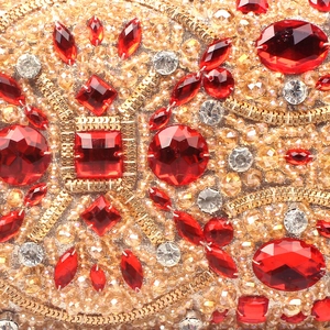 Golden beaded evening clutch bag with sparkling red crystals in geometric patterns