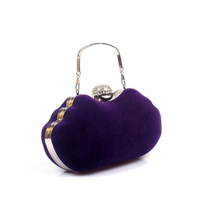 Detail of purple velvet evening clutch with crystal sphere clasp and metal chain handle