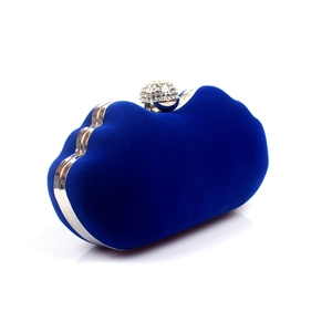 Detail of royal blue velvet evening bag with silver frame and sparkling diamond clasp