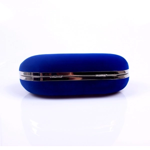 Detail view of the deep blue velvet texture and silver metal frame on the evening clutch bag