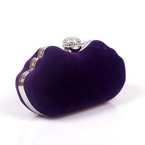 Detail of purple velvet evening clutch with silver trim and rhinestone crystal clasp