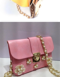 Dettaglio borsa rosa in finta pelle con fiori di perle 3D e catena dorata