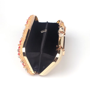 Interior view of gold evening clutch featuring black fabric lining and functional inner pockets