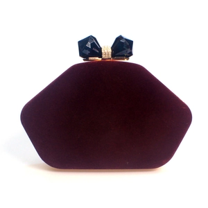 Elegant pentagonal velvet clutch bag in deep purple with crystal-encrusted bow clasp