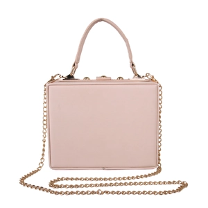 Close-up of pink square box evening bag with golden metal chain and elegant handle