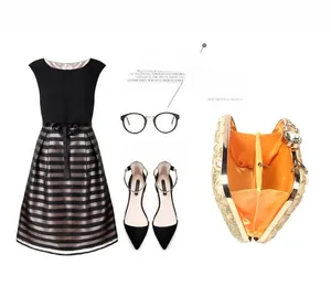 Flat lay of embroidered lace evening clutch bag with black stripe dress and ballet flats