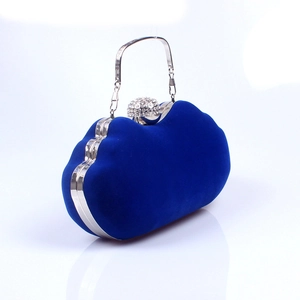 Close-up of luxury navy blue velvet evening bag with silver crystal-studded sphere clasp