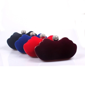 Detail of four velvet evening clutch bags with sparkling rhinestone ball clasps in various colors