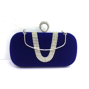 Macro view of sapphire blue velvet evening bag with silver rhinestone fringe and ring clasp