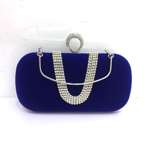 Detail of royal blue velvet evening bag with silver crystal ring clasp and handle