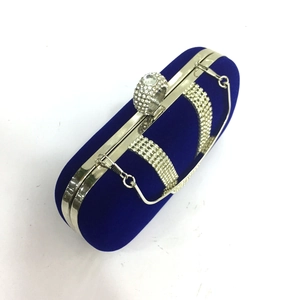 Royal blue velvet evening clutch bag with sparkling rhinestone ring handle and metal frame