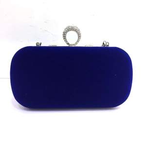 Royal blue velvet evening clutch bag with sparkling diamond-encrusted round buckle and silver hooks