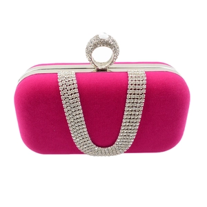 Fuchsia velvet clutch detail with U-shaped rhinestone chains and sparkling ring clasp