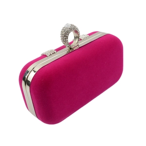 Macro detail of rose velvet clutch with diamond ring clasp and silver metal frame