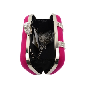 Detail of rose red velvet clutch with rhinestones, silver frame and chain strap