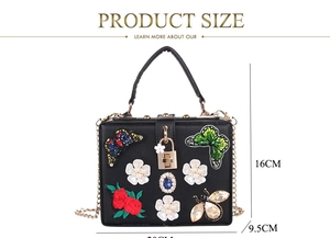 Detailed size view of luxury butterfly embroidered clutch with pearl and flower accents