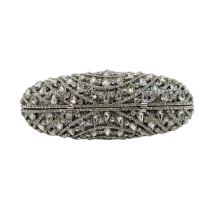 Close-up of luxury silver clutch with sparkling teardrop crystals and metal clasp