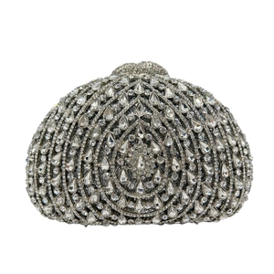 Silver shell clutch bag featuring radiant teardrop crystals and secure snap closure