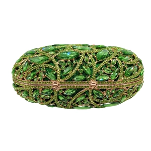 Macro view of green crystal clusters on an ornate golden floral metal frame clutch