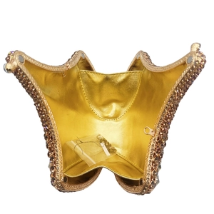 Close-up of golden butterfly evening clutch bag with crystal rhinestones and inner lining