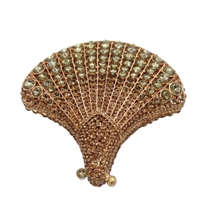 Detailed view of hedgehog-shaped evening clutch bag with champagne crystals and metallic frame