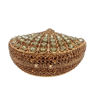 Macro shot of fan-shaped clutch bag with champagne gold rhinestones and crystals