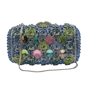 Luxury evening clutch bag with colorful crystals and floral rhinestones on white background
