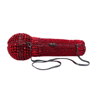Detail of red rhinestone-encrusted microphone clutch with gunmetal chain strap