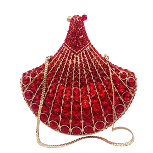 Detailed view of fan-shaped clutch bag with deep red rhinestones and gold metal chain