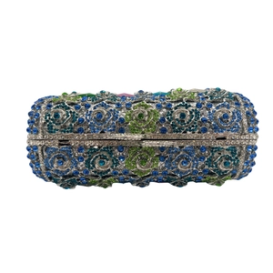 Detailed macro view of the rose pattern made from blue and green crystals on the evening bag