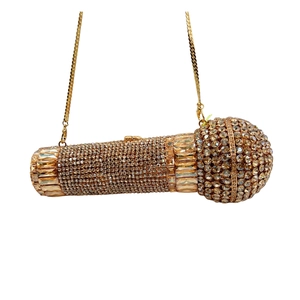 Macro shot of microphone clutch bag featuring champagne rhinestones and gold chain