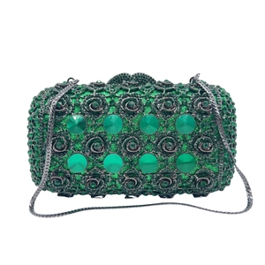 Luxury emerald crystal clutch bag with silver chain and green gemstone accents