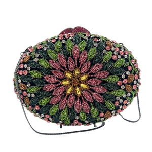 Macro detail of luxury evening bag with multicolored crystal floral pattern and metal chain