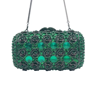 Detail of green crystal evening clutch with large faceted gems and silver chain strap