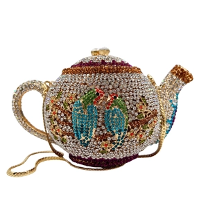 Detail of crystal encrusted teapot evening bag featuring colorful parrot floral patterns