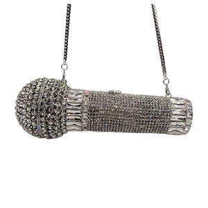 Macro view of microphone-shaped clutch bag with silver rhinestones and chain strap