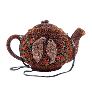Close-up of crystal teapot evening bag with detailed rhinestone bird and floral pattern