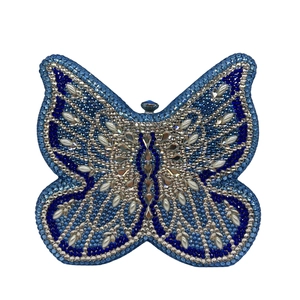 Detailed close-up of blue and silver rhinestones on a butterfly-shaped clutch bag