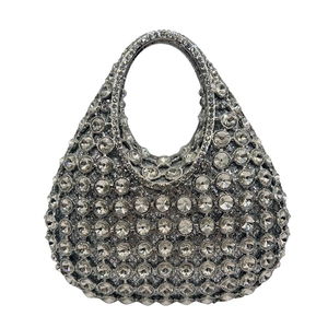 Detailed view of silver evening clutch bag with dense sparkling rhinestone embellishments