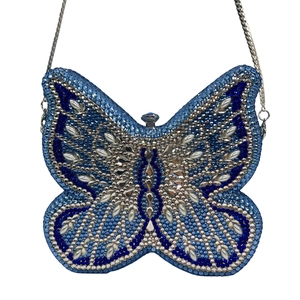 Detail view of a luxury butterfly clutch bag with blue and silver crystals and fine chain
