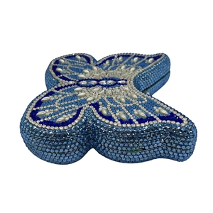 Detail of luxury butterfly evening clutch bag with blue rhinestones and pearls