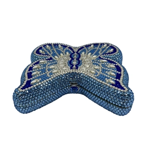 Macro view of blue crystals and pearls embellishing this butterfly evening clutch bag