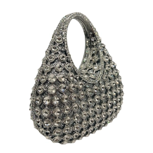 Macro shot of silver crystal teardrop clutch bag with luxurious rhinestone inlay