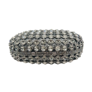 Detail shot of the silver clutch bag with sparkling crystals and a secure metal hinge