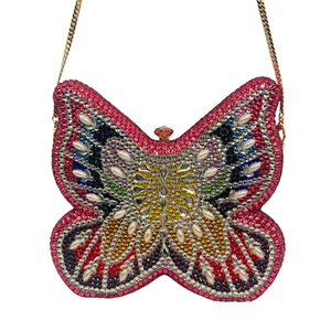 Detailed macro of crystal-encrusted butterfly clutch with colorful rhinestones and pearls