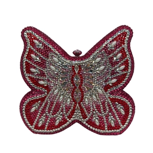 Detailed view of the luxury butterfly clutch featuring vibrant red and pink crystals