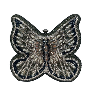 Detailed view of butterfly evening clutch encrusted with grey rhinestones and pearls