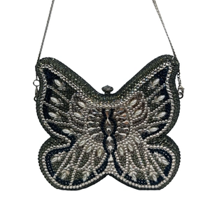 Detail of butterfly evening clutch bag with black and white crystals and teardrop pearls