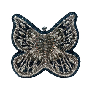 Exquisite butterfly clutch bag with deep blue crystals and pearl accents close-up detail